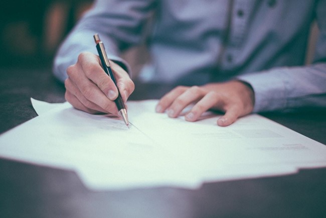 a man signing an invoice